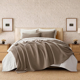 EverGrace waffle blanket draped on bed demonstrates luxurious oversized coverage for king beds.