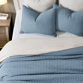 Evergracehome Kinsey king-size quilt 108 by 96 inches draped on bed.
