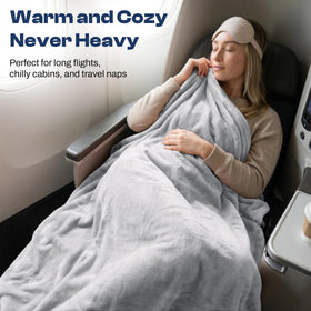 EverSnug blanket attached to luggage via sleeve for easy airport travel.