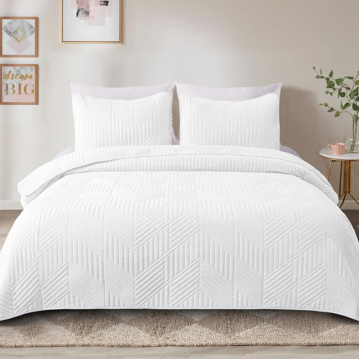 Two matching pillow shams complement the quilt set with cohesive white styling