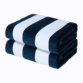 Exclusivo Mezcla cabana stripe towel dark navy at the beach, soft and absorbent.