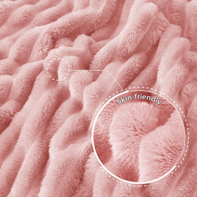 Exclusivo Mezcla pink throw blanket draped on sofa for cozy evenings