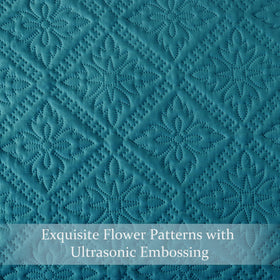 Exclusivo Mezcla teal quilt creates a modern focal point in any bedroom.