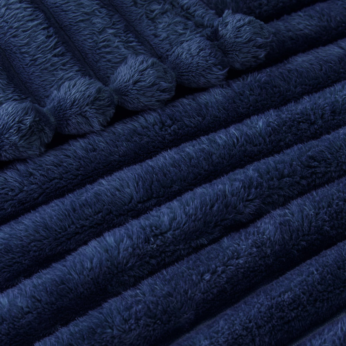 Exclusivo Mezcla blanket gracefully draped as a bed throw