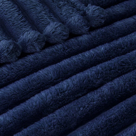 Exclusivo Mezcla blanket gracefully draped as a bed throw