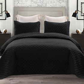 Exclusivo Mezcla reversible queen quilt in black with dual-sided design for versatile styling.