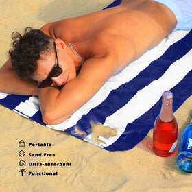 Exclusivo Mezcla stripe-pattern navy towel for poolside photos.