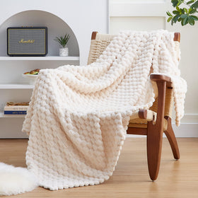 EXQ Home fleece blanket twin size 60x80 on a couch for cozy comfort.