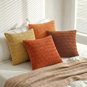 Fancy Homi burnt orange stripe pillow cover on a bedroom setting