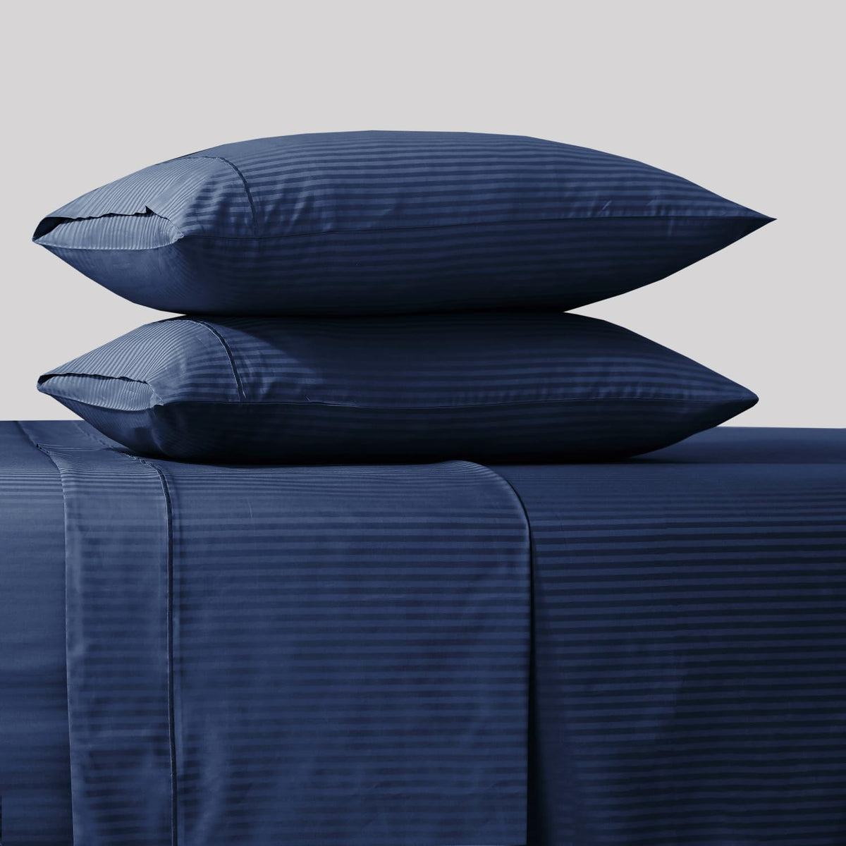 Closeup of Feather & Stitch New York 500TC damask sheet texture reveals silky sateen finish