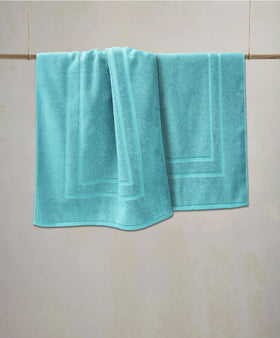 Feather & Stitch New York bathroom mat in a cozy home setting