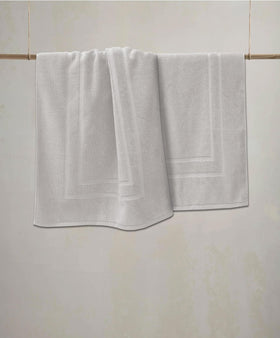 Feather & Stitch New York water-absorbent mat in bathroom, keeps floors dry.