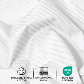 Feather & Stitch New York embroidery on flat sheet and pillowcases signals premium style.