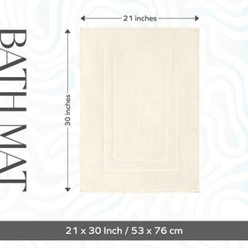 FEATHER & STITCH NEW YORK fast-drying cotton bath mat keeps floors fresh.