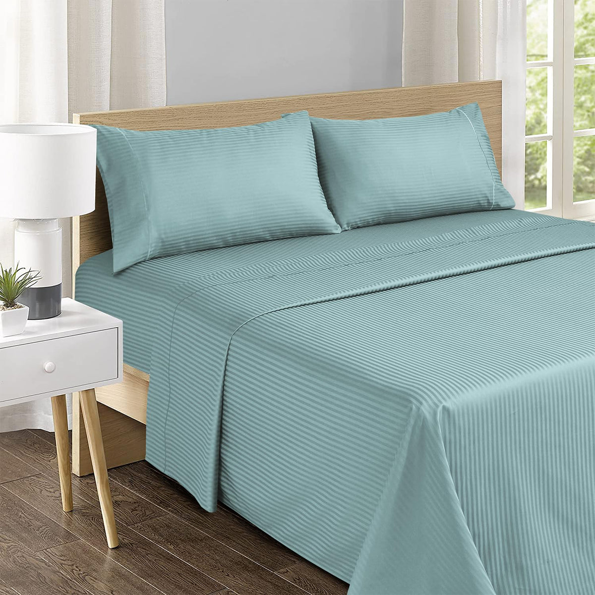 Feather & Stitch New York flat sheet and pillowcases feature embroidered detailing for refined bedding.