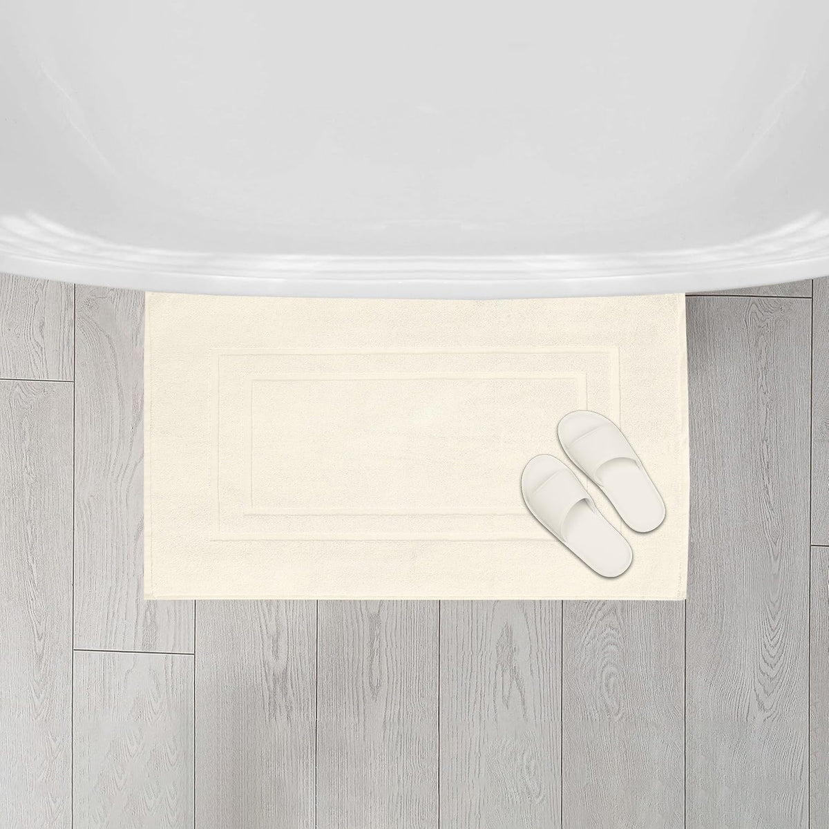 FEATHER & STITCH NEW YORK quick-dry bath mat reduces damp spots after showers.