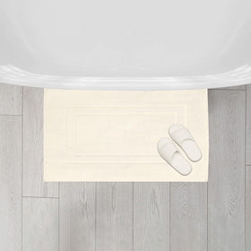FEATHER & STITCH NEW YORK quick-dry bath mat reduces damp spots after showers.