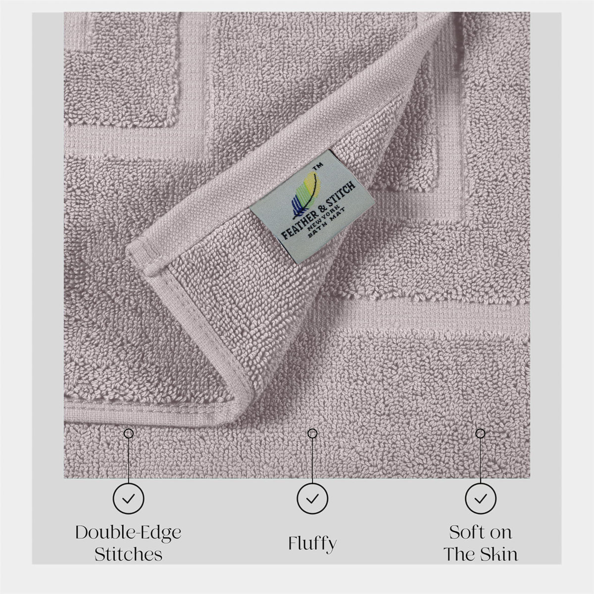 Pair of taupe bath mats from Feather and Stitch New York laid by the shower.