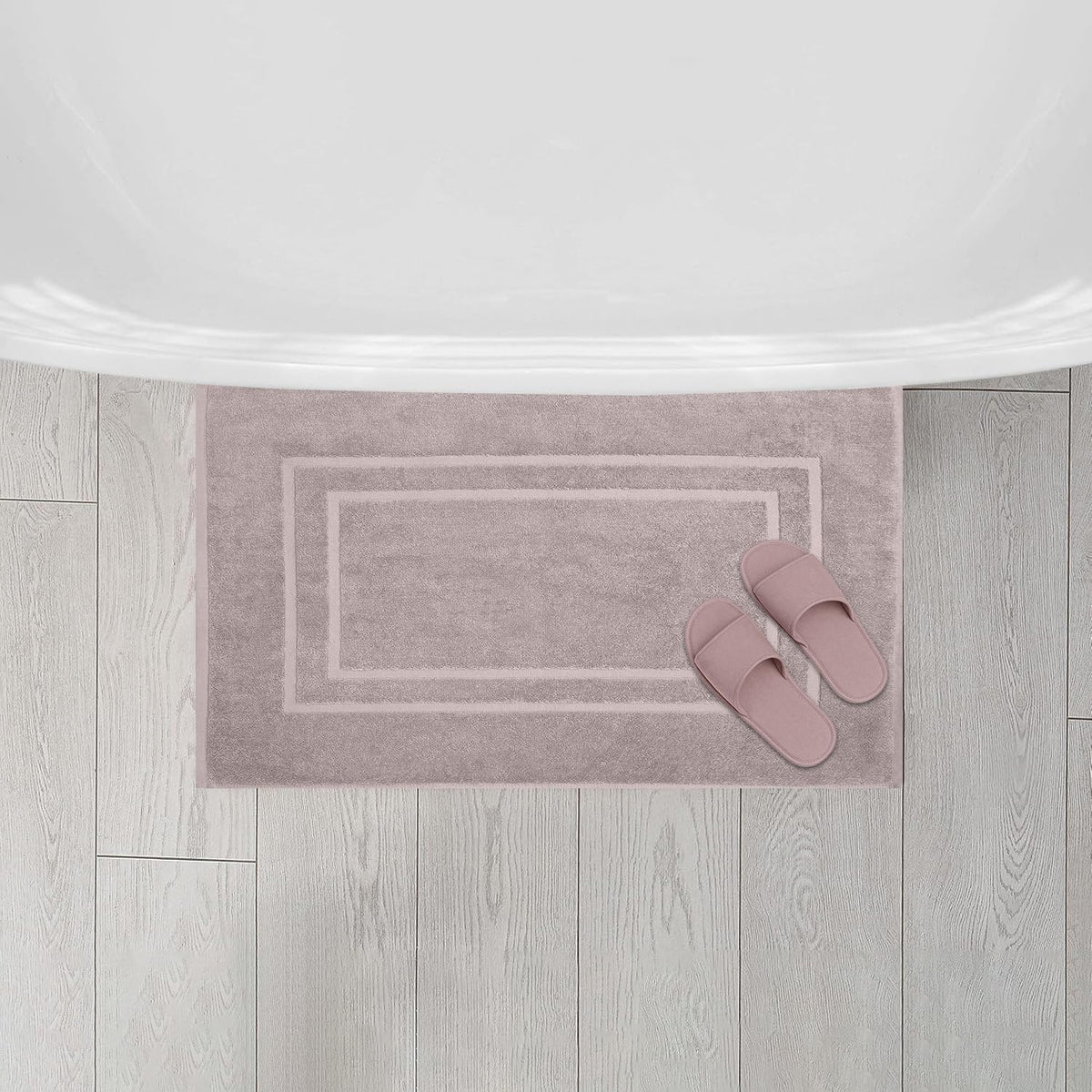 Taupe bath mats from Feather and Stitch New York complement contemporary decor.