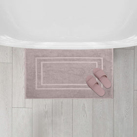 Taupe bath mats from Feather and Stitch New York complement contemporary decor.