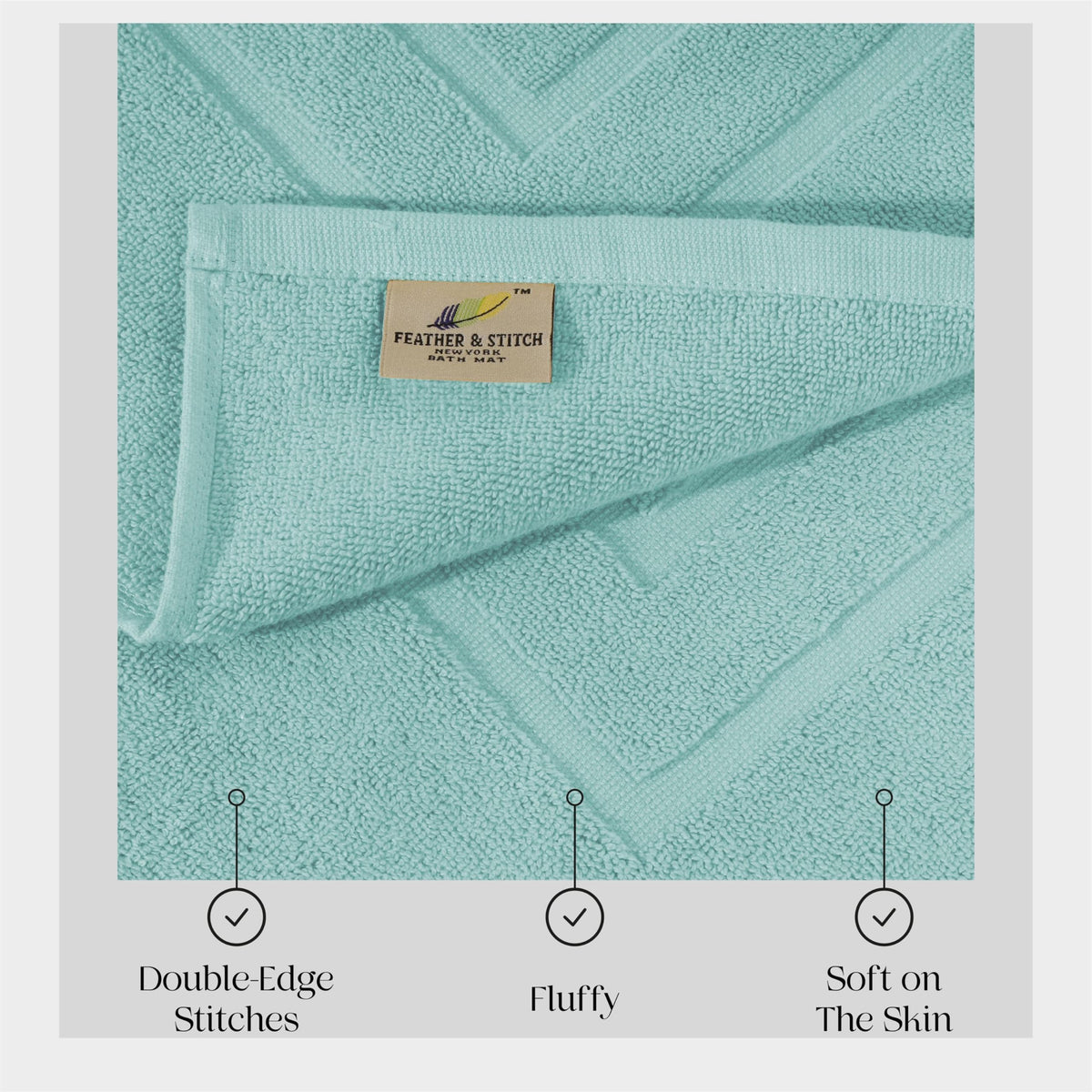 Feather & Stitch Sea Foam bath mat in a bathroom scene.