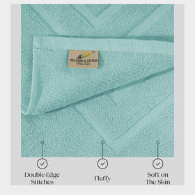 Feather & Stitch Sea Foam bath mat in a bathroom scene.