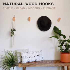 Felidio beech wood wall hooks holding towels in bathroom, space-saving solution.