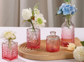 Fixwal pink vases on dining table centerpiece with fresh or artificial flowers.