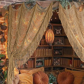 Flber macrame curtain in khaki decorates doorway with soft light filtering