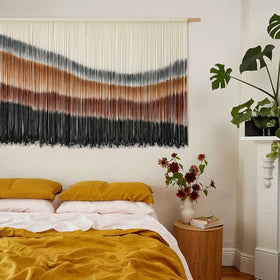 Flber geometric knots detail creates an artisanal gallery wall focal point.
