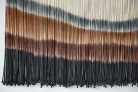 Flber wall decor unites rooms with rich espresso tones.