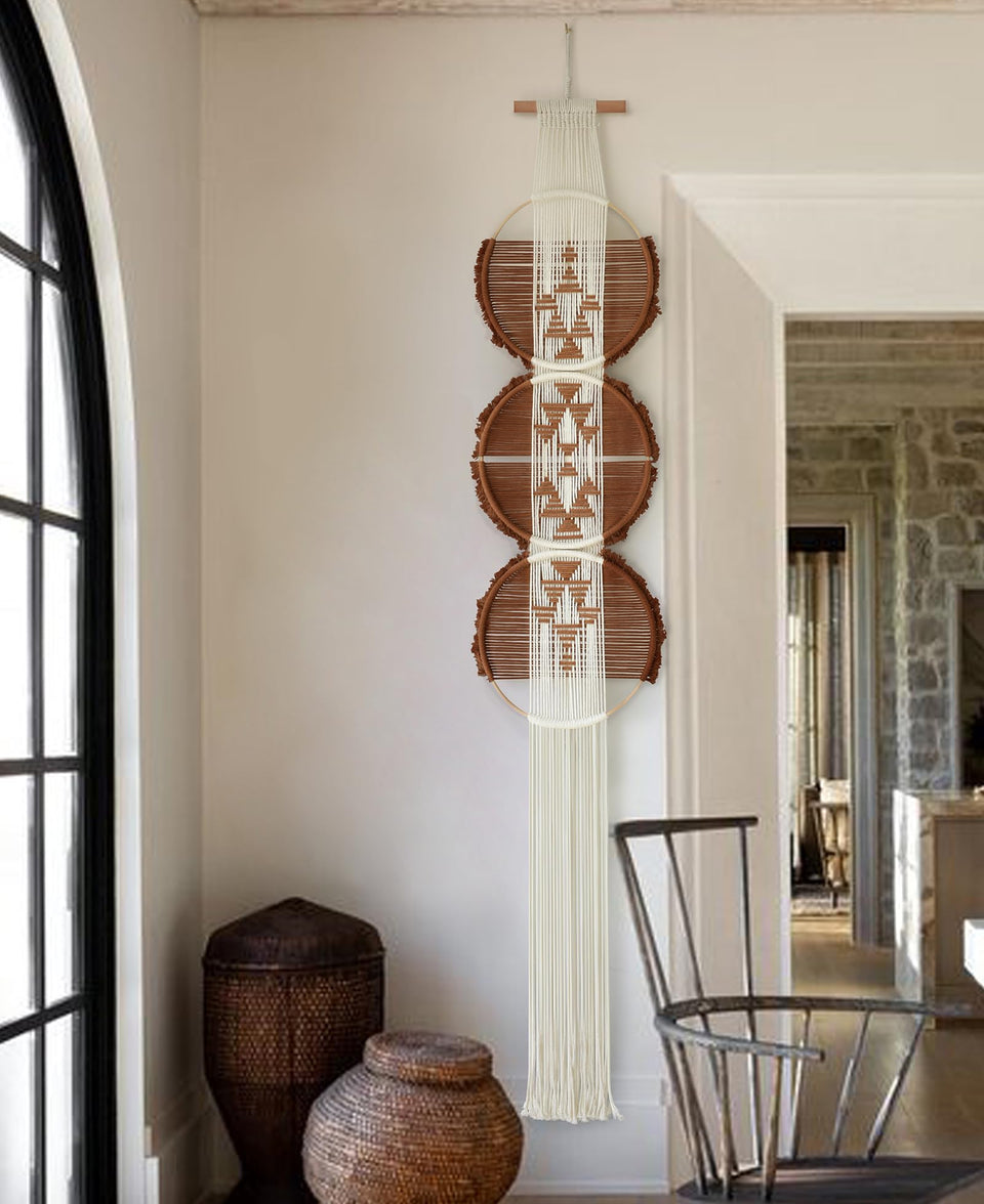 Flber macrame wall hanging with three circles adds subtle texture to modern living rooms.