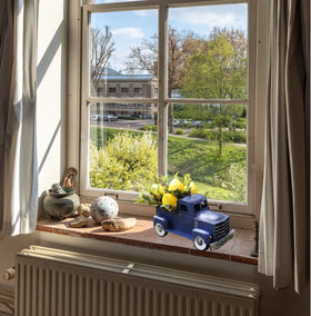 FLOROAD blue farmhouse truck brings spring vibes to living spaces.