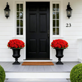 Flortevera trailing geraniums on yard urns create vertical interest.