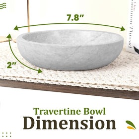Close-up of FNTSTICGOODS travertine bowl showing white marble finish on a shelf.