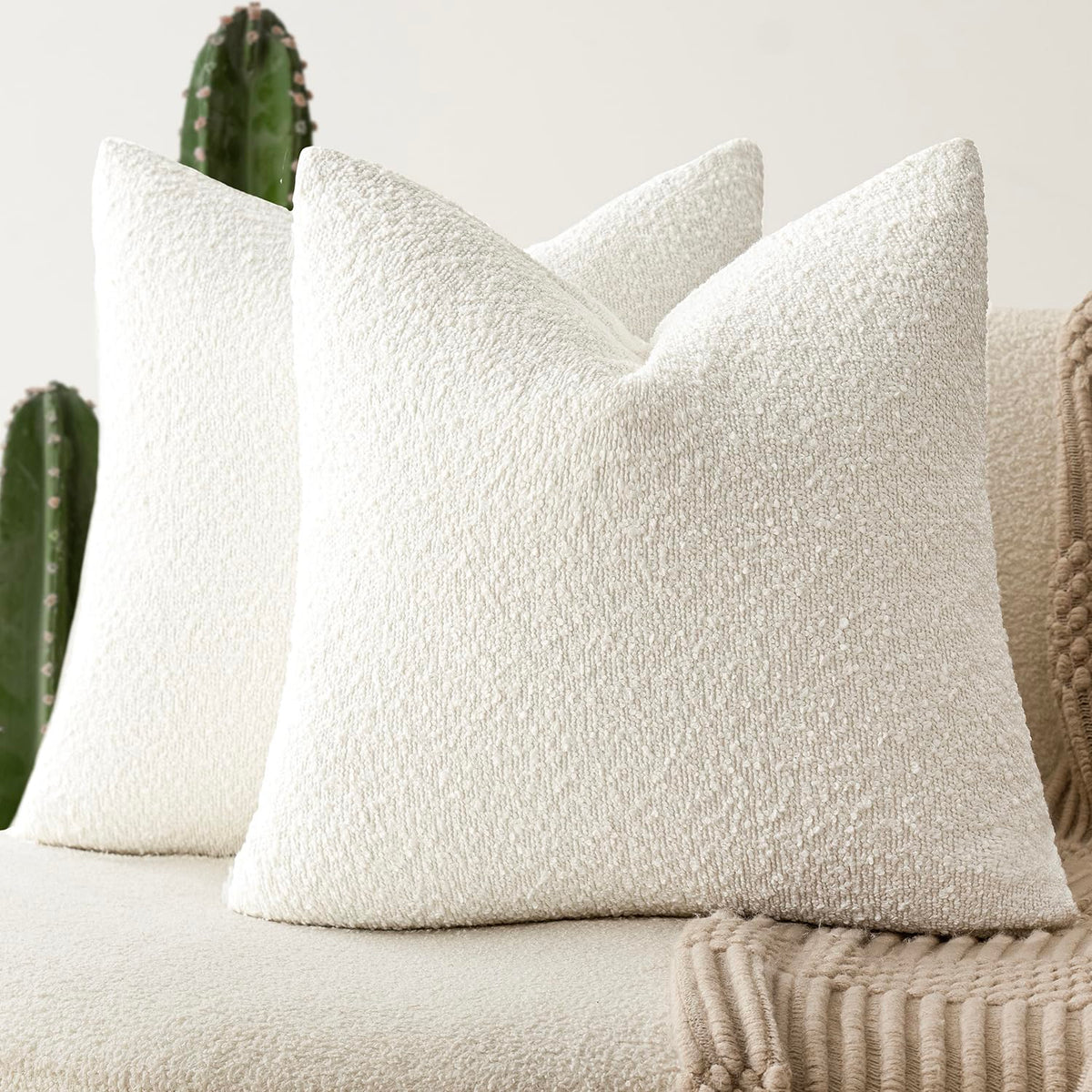 Foindtower boucle pillow cover in white adds soft texture to a sofa.