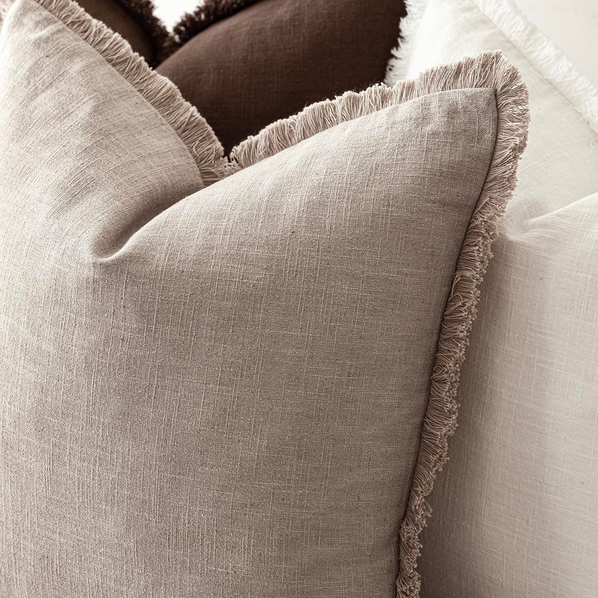 Foindtower fringe covers on a bed create a cozy, inviting bedroom accent.