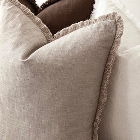 Foindtower fringe covers on a bed create a cozy, inviting bedroom accent.