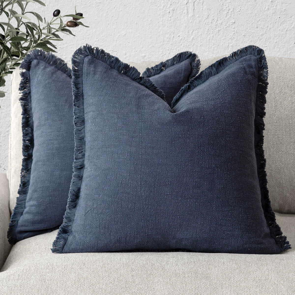 Foindtower navy fringe pillow cover enhances boho style on the living room sofa.