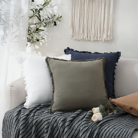 Foindtower living room decor with navy pillow boosts cozy appeal.