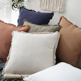 Foindtower outdoor-ready pillow cover styling on patio with neutral tones.