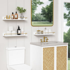 Forbena gold floating shelves installed over toilet for extra bathroom storage.