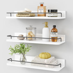 Forbena white floating shelves over the toilet offer compact storage.