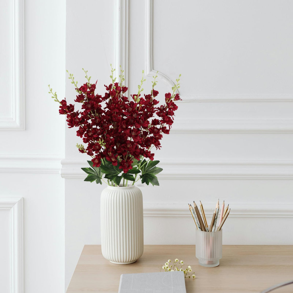 Living room display featuring burgundy delphinium from Fqueelvys