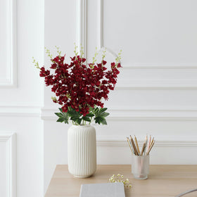Living room display featuring burgundy delphinium from Fqueelvys