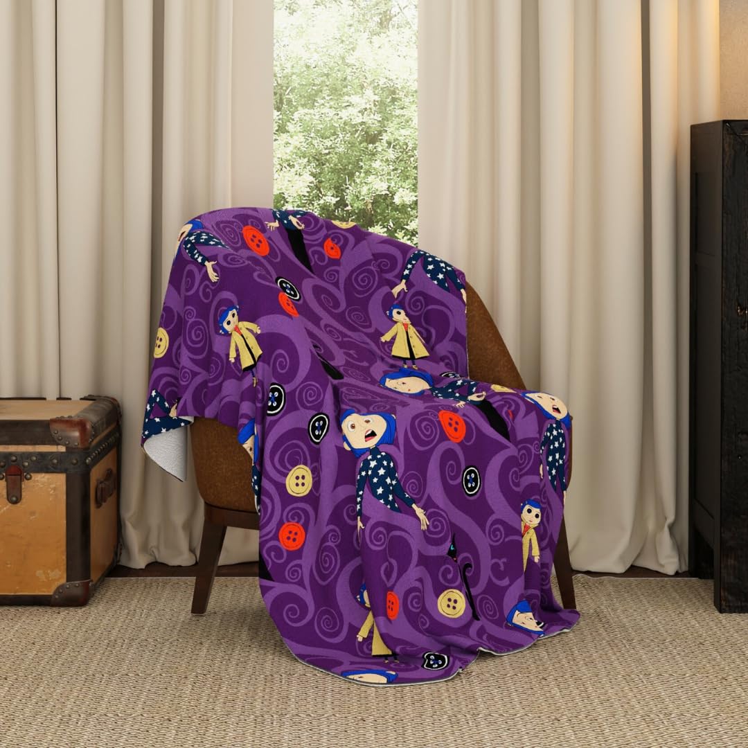 Franco Coraline throw with button eyes print — cozy movie night essential