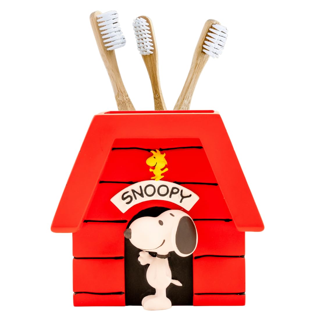 Franco Snoopy doghouse toothbrush holder on counter with playful charm and organization.