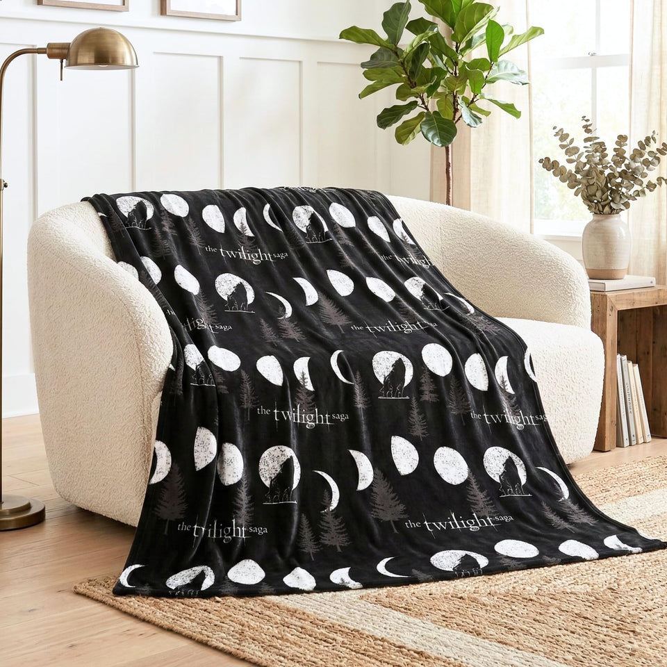 Franco Twilight Saga Throw with teal and pink outlines on charcoal fabric offers bold decor.