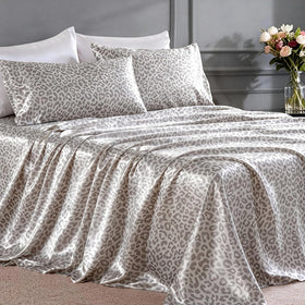 FreshCulture leopard satin sheets set on bed for luxurious comfort.