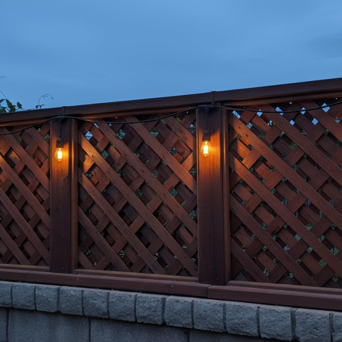 Frienda outdoor decor lit by string lights creating cozy backyard ambiance